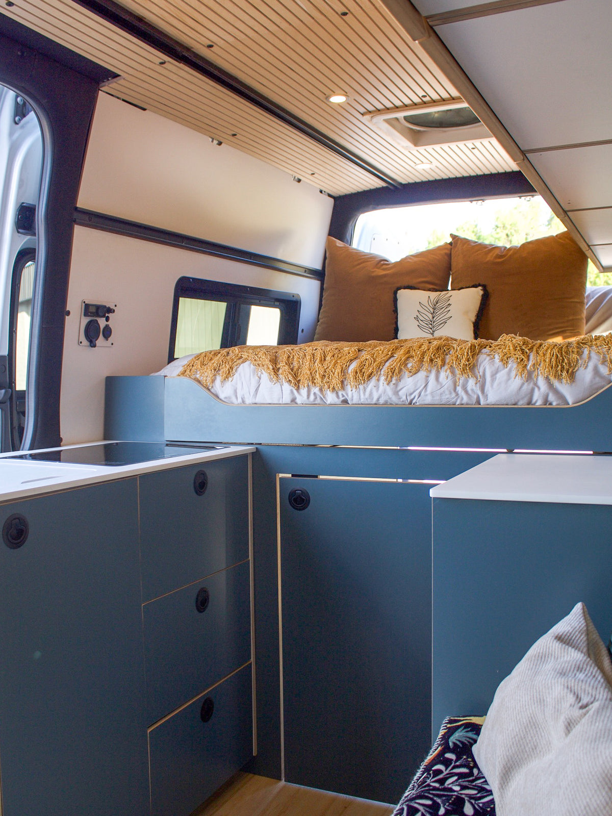 Mars rear bed and galley cabinets seen from the front of the van