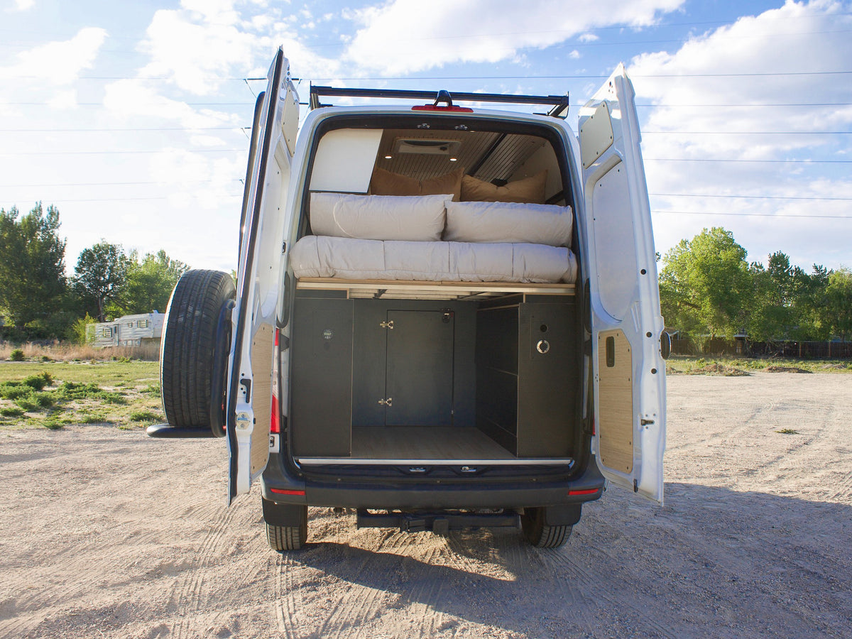 Rear doors open on Mars, showing the bed platform and garage storage underneath