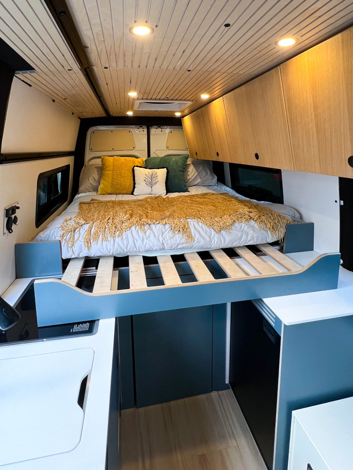 Mars bed extended over the galley cabinet in sleep mode