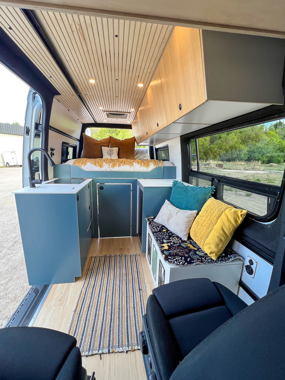 Bench seat with pillows across from the galley in Mars