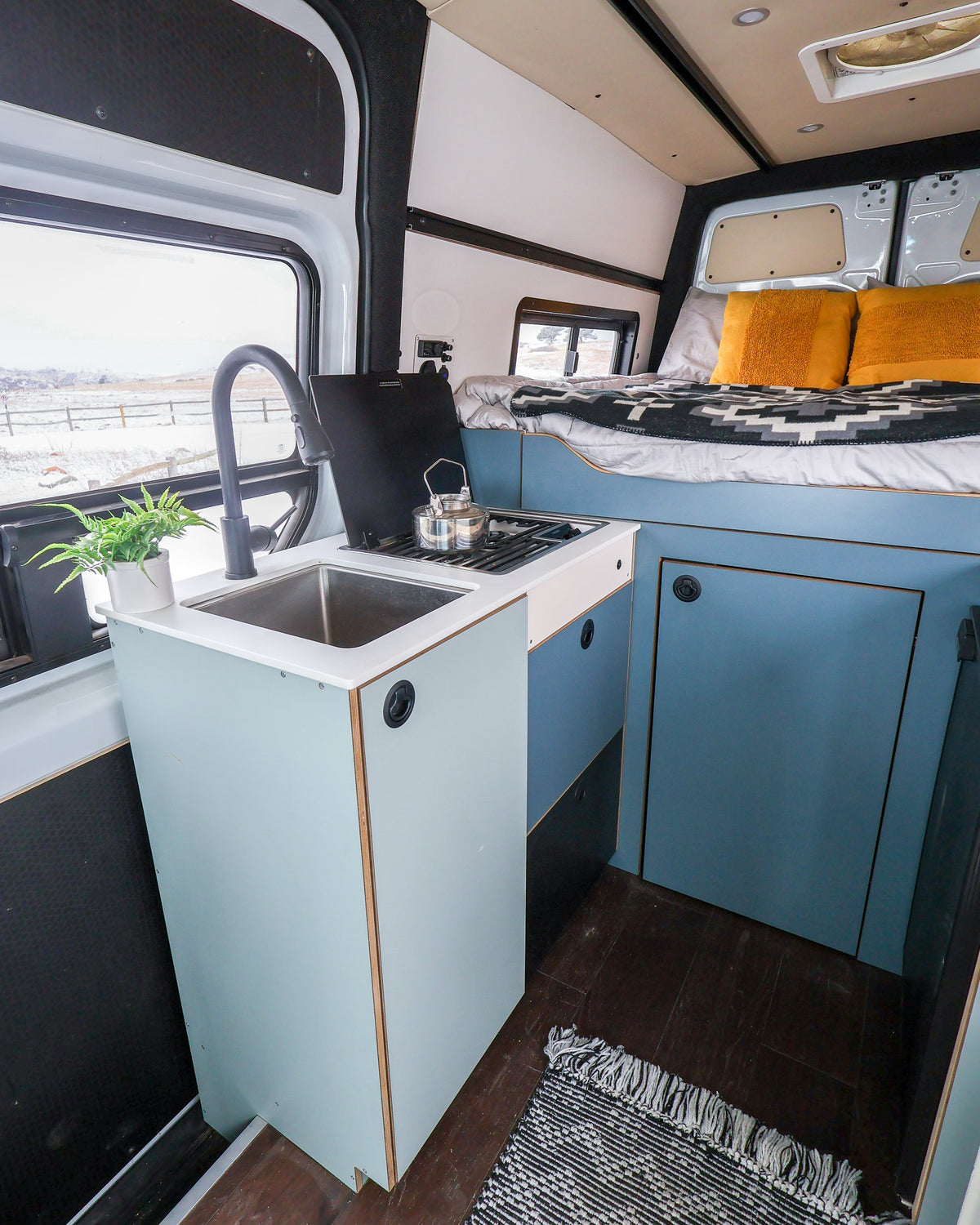 Featherbuilt galley cabinet with sink in a Sprinter van