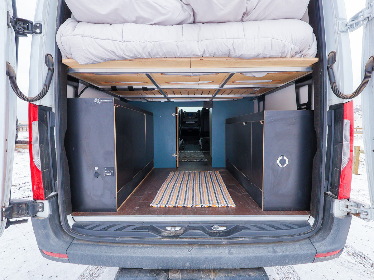 Featherbuilt storage cabinets under the bed platform in a Sprinter van
